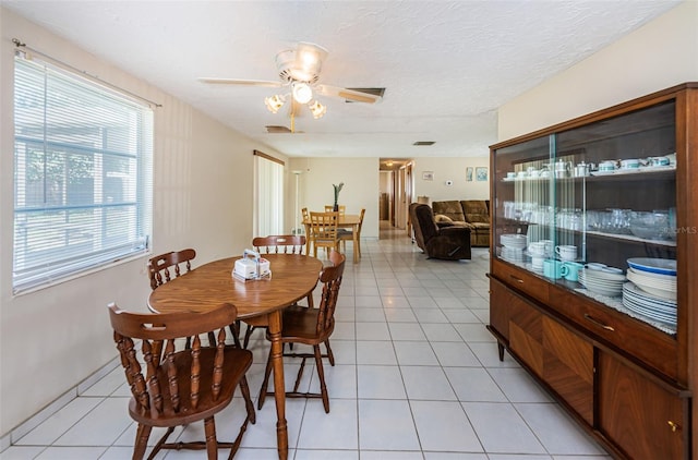 dining room featuring light tile floors and ceiling fan