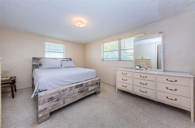 bedroom with multiple windows and a textured ceiling