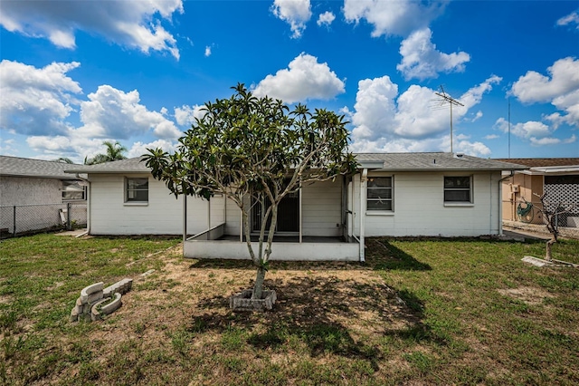 rear view of property with a yard and a patio