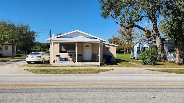 bungalow-style home with a front yard