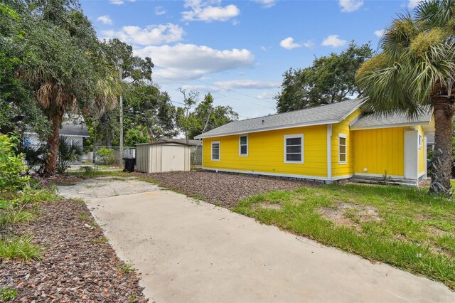 view of side of home featuring a storage unit