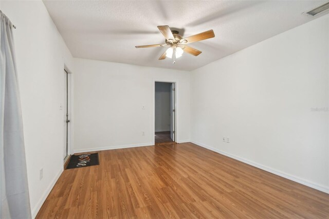 unfurnished room with ceiling fan and light hardwood / wood-style flooring