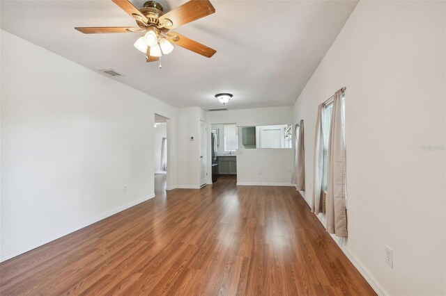 unfurnished living room featuring ceiling fan and hardwood / wood-style flooring