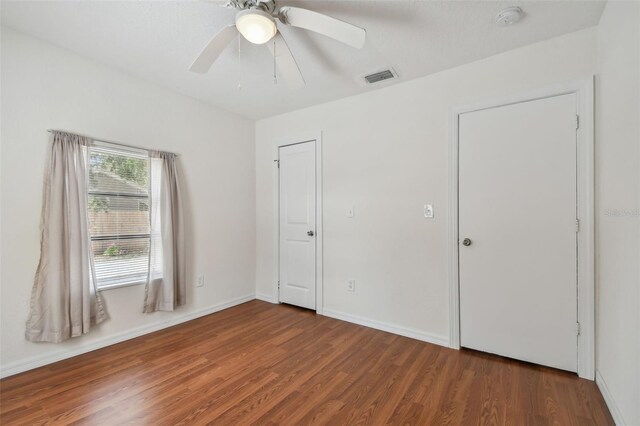 unfurnished bedroom featuring ceiling fan and hardwood / wood-style flooring