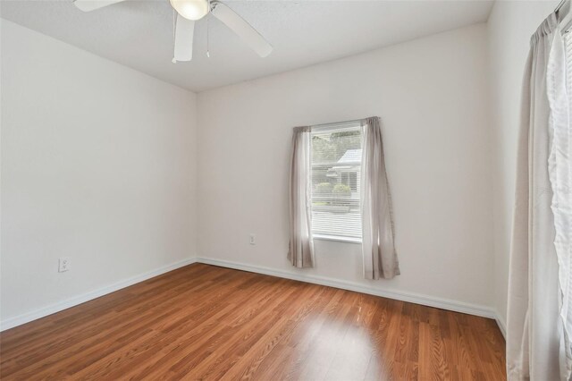 spare room featuring ceiling fan and hardwood / wood-style floors