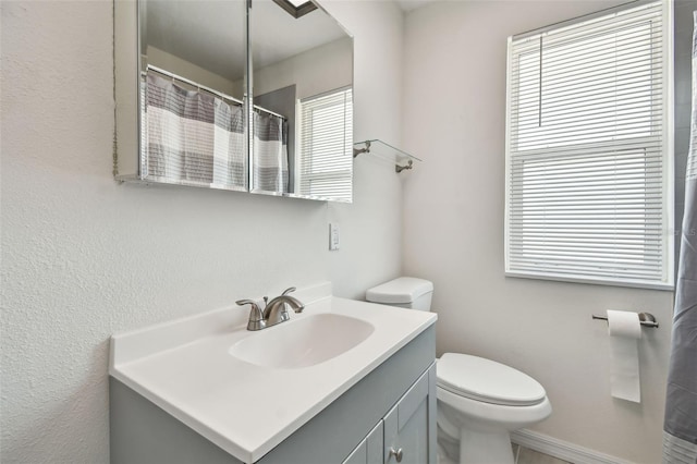 bathroom featuring toilet and vanity