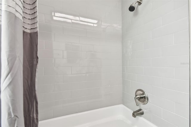 bathroom with shower / bath combination with curtain