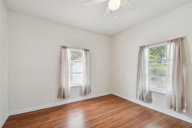 empty room featuring hardwood / wood-style flooring and ceiling fan