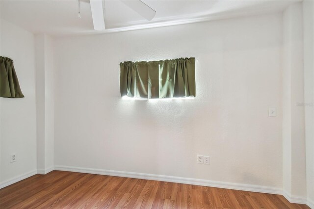 unfurnished room with ceiling fan and hardwood / wood-style floors