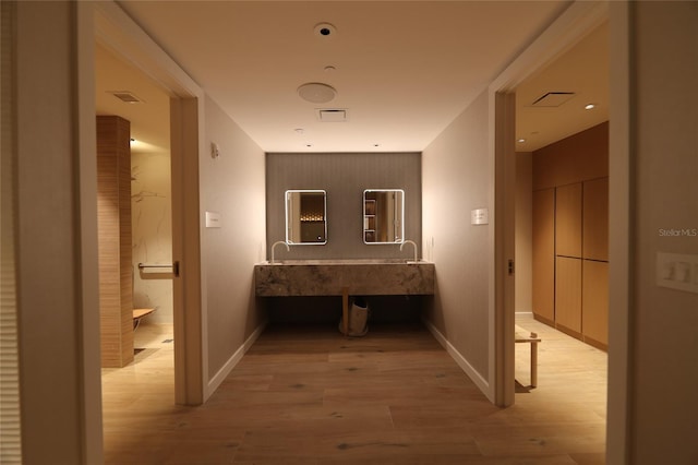 corridor with light hardwood / wood-style floors