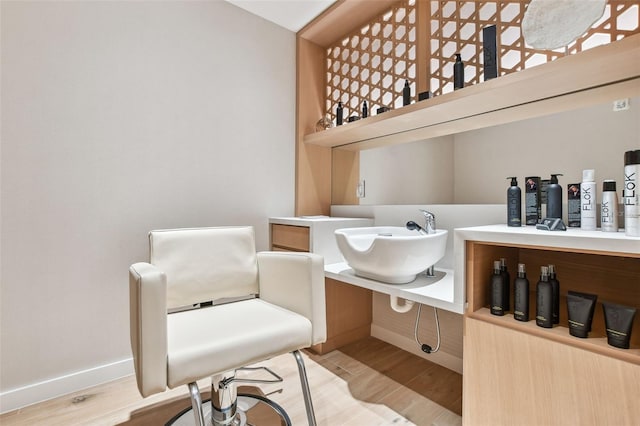 bathroom with hardwood / wood-style floors and sink