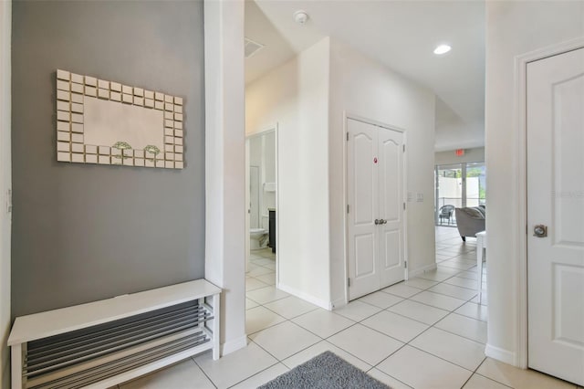 hall featuring light tile patterned floors