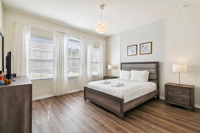 bedroom featuring dark wood-type flooring and multiple windows