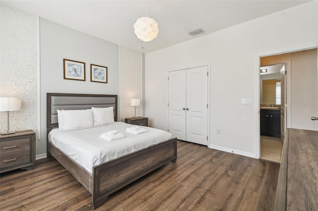 bedroom featuring a closet and dark hardwood / wood-style flooring