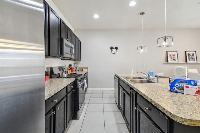 kitchen with pendant lighting, stainless steel appliances, light tile patterned flooring, and sink