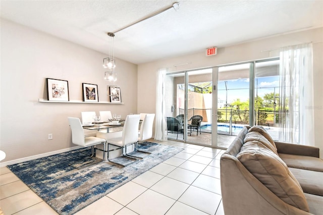 dining room with a textured ceiling and light tile patterned flooring