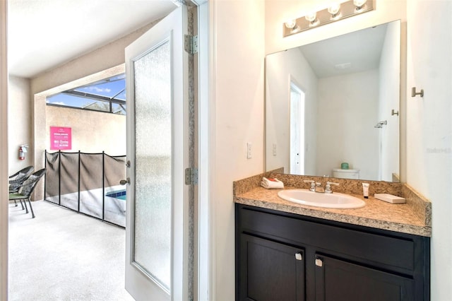 bathroom with vanity, toilet, and a healthy amount of sunlight