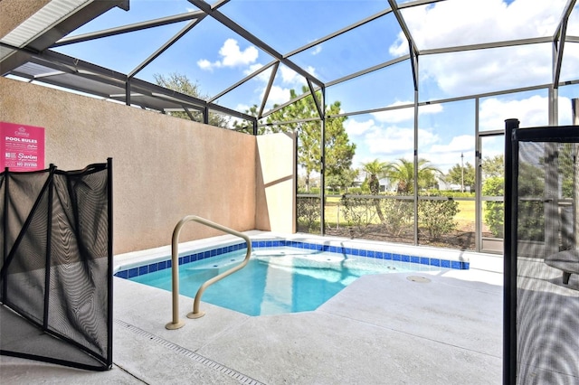 view of pool featuring glass enclosure and a patio