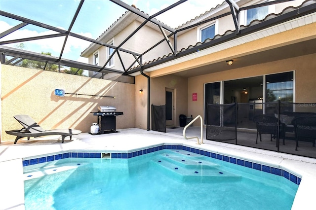 view of swimming pool with grilling area, a lanai, and a patio