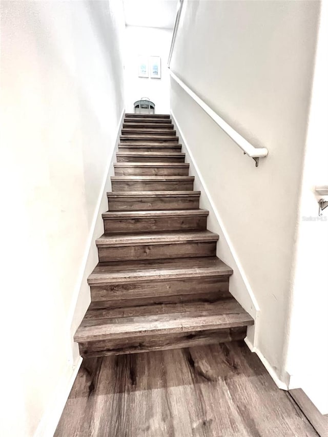 stairway featuring hardwood / wood-style flooring