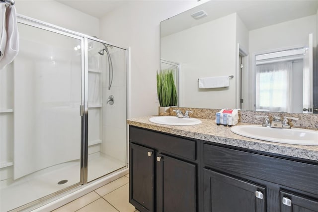 bathroom with vanity, an enclosed shower, and tile patterned floors