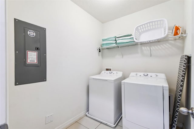 laundry area featuring light tile patterned floors, independent washer and dryer, and electric panel