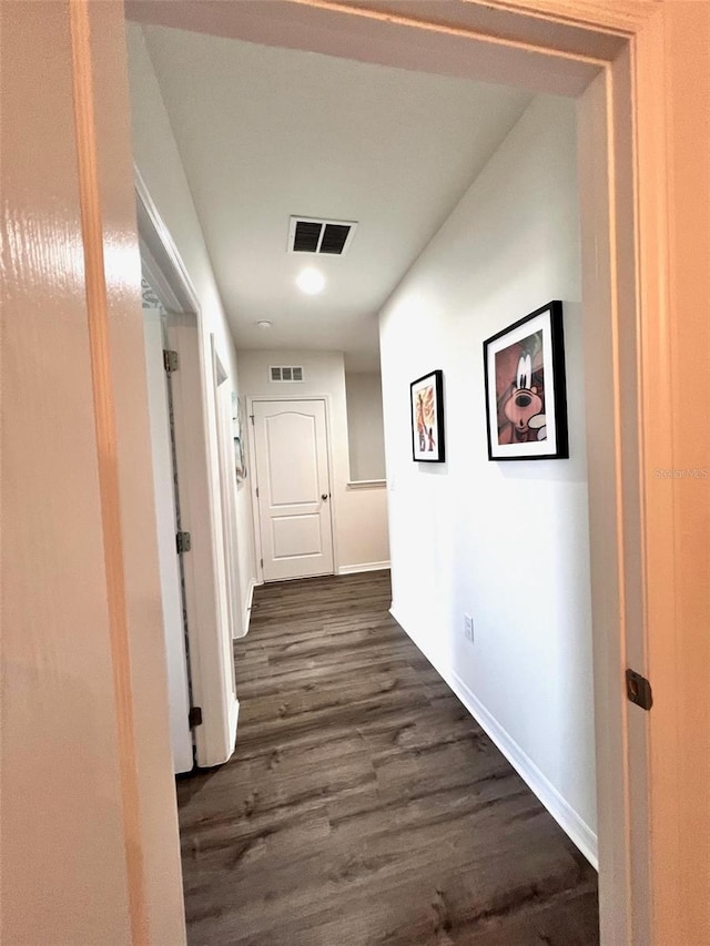 hallway with dark hardwood / wood-style floors