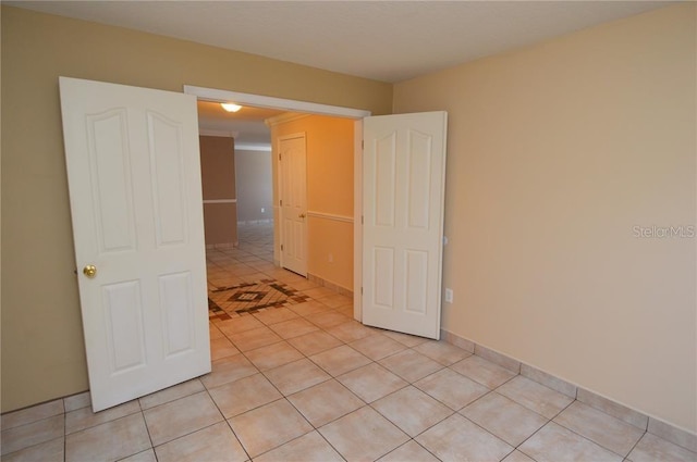 spare room with light tile floors