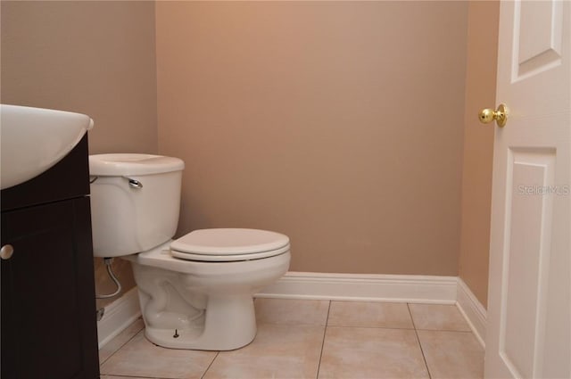 bathroom with vanity, tile floors, and toilet