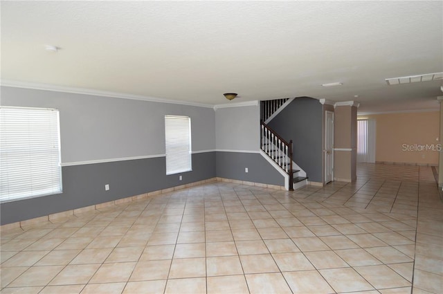 tiled spare room with crown molding