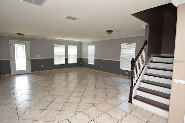 tiled spare room with ornamental molding