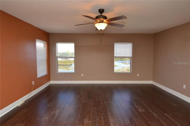 unfurnished room featuring dark hardwood / wood-style floors and ceiling fan