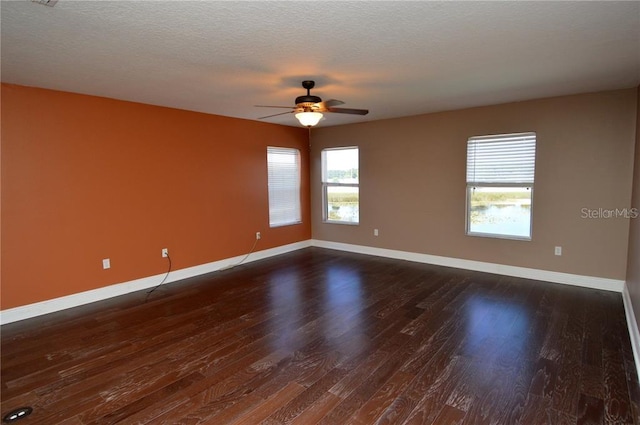 unfurnished room with dark hardwood / wood-style flooring, a textured ceiling, and ceiling fan