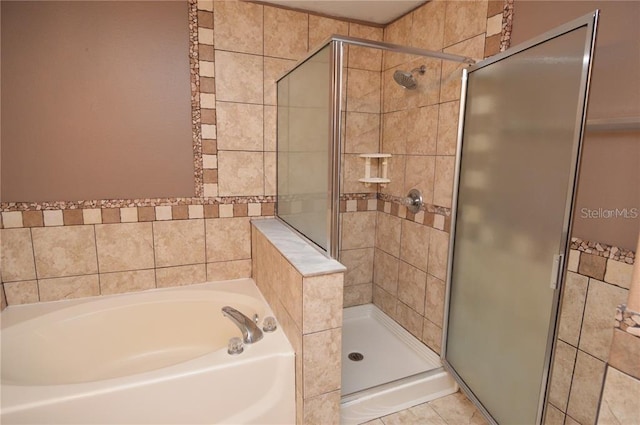 bathroom with tile floors and independent shower and bath