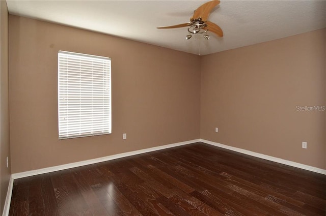 spare room featuring plenty of natural light, dark hardwood / wood-style floors, and ceiling fan