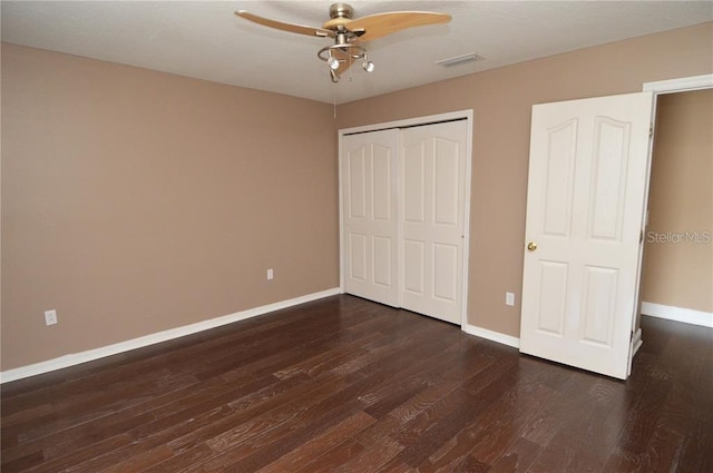 unfurnished bedroom featuring a closet, ceiling fan, and dark hardwood / wood-style flooring