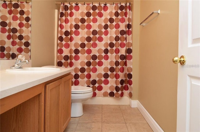 bathroom featuring vanity, tile flooring, and toilet