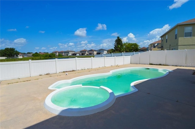 view of swimming pool featuring a patio area and an in ground hot tub