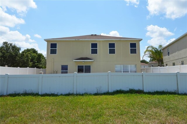 back of house featuring a yard