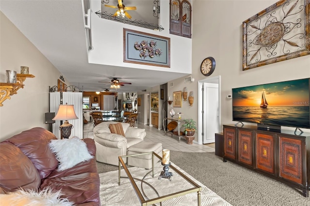 tiled living room with ceiling fan