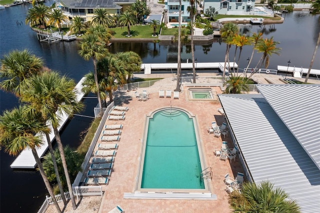 view of pool with a patio and a water view