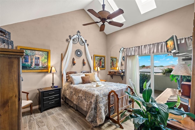 bedroom featuring access to exterior, lofted ceiling with skylight, ceiling fan, and wood-type flooring