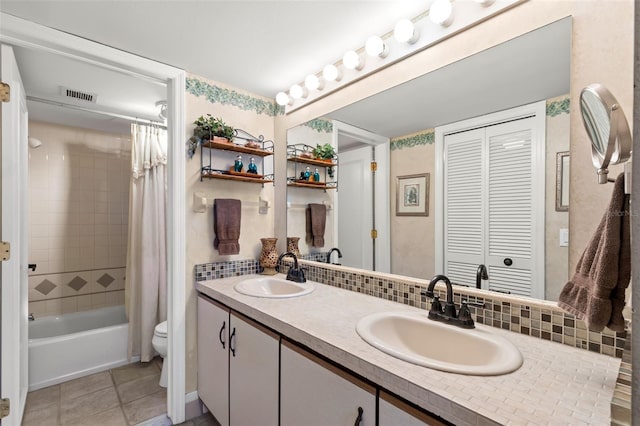 full bathroom with tasteful backsplash, shower / bath combo with shower curtain, tile patterned flooring, toilet, and double sink vanity