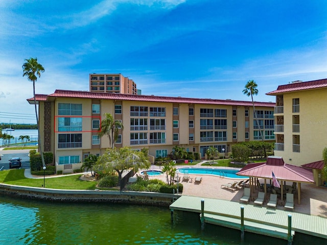 view of property featuring a water view and a community pool