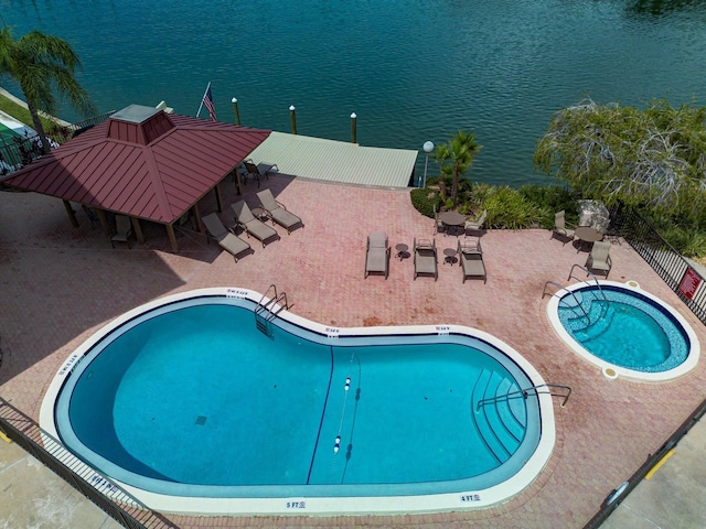 view of swimming pool with a gazebo and a water view