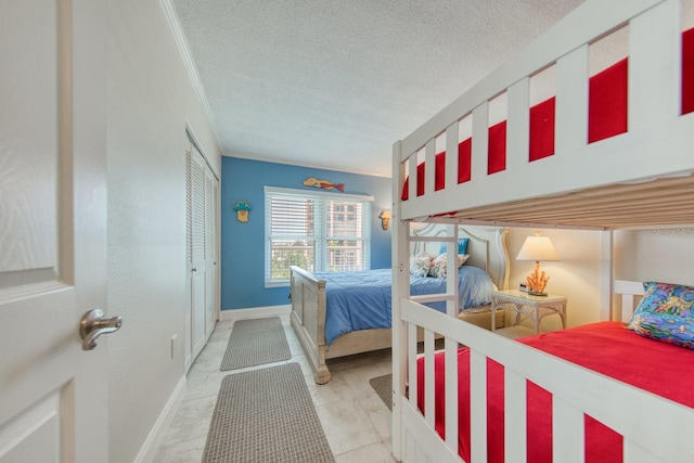 bedroom featuring light tile patterned floors, a closet, and a textured ceiling