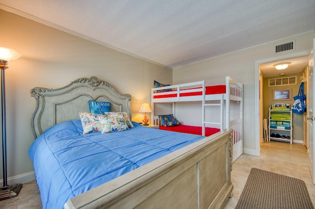 tiled bedroom with crown molding and a textured ceiling