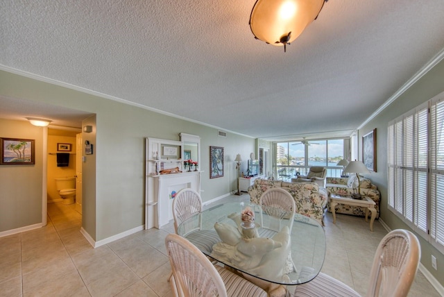 tiled dining space with crown molding, a wealth of natural light, and a textured ceiling