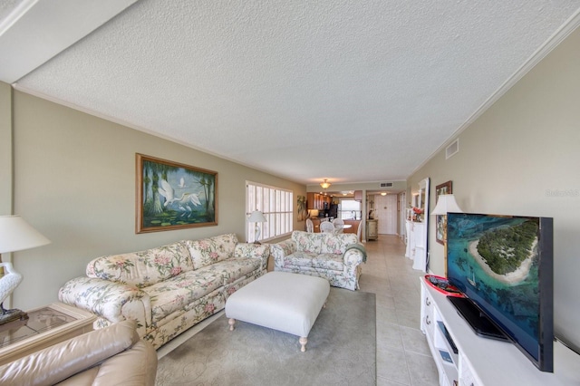 tiled living room with crown molding and a textured ceiling