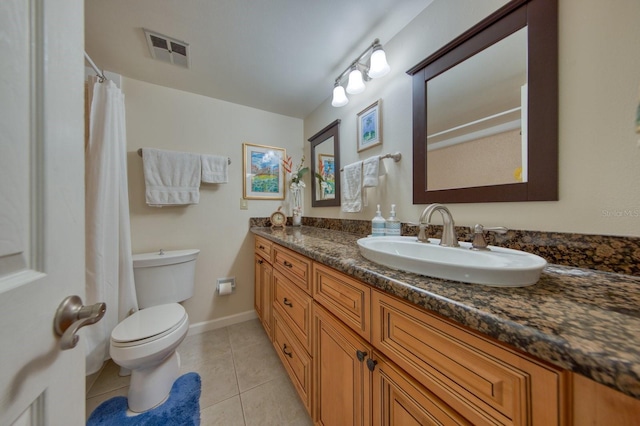 bathroom featuring tile patterned floors, toilet, and vanity